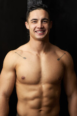 Fototapeta premium Shower, water and man with portrait in studio with body cleaning, care and morning routine. Hygiene, wellness and skincare for dermatology and skin glow with washing, grooming and black background