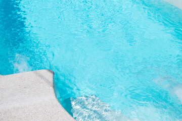 close up detail view of the edge of a pool of clear water