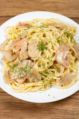 angle view spaghetti with creamed mushroom and bacon sauce at vertical composition