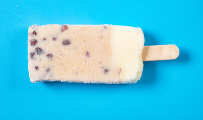 top view milkshake flavor popsicle with red beans on blue background