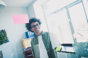 Photo of happy positive broker wear khaki shirt spectacles having brainstoming meeting indoors...