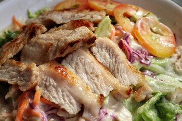 Fresh vegetable salad and pork steak