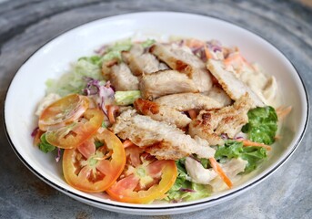 Fresh vegetable salad and pork steak