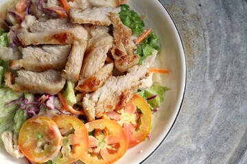 Fresh vegetable salad and pork steak