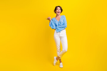 Full length photo of impressed woman dressed print blouse look indicating at promo empty space...