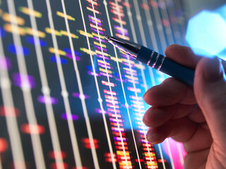 Genomic Research, Scientist examining DNA profiles after analytical testing in the lab.