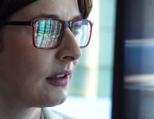 Genomics, Scientist viewing human DNA profiles on screen during testing in the lab
