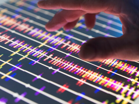 Genomic Research, Scientist examining DNA profiles after analytical testing in the lab.