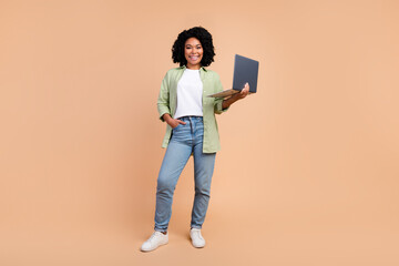 Full size photo of nice young lady use laptop wear shirt isolated on beige color background