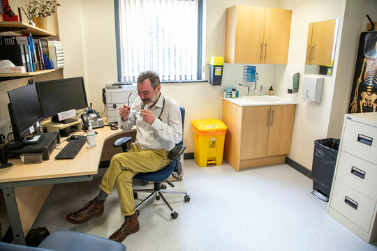 Doctor working at a desk in a medical office 