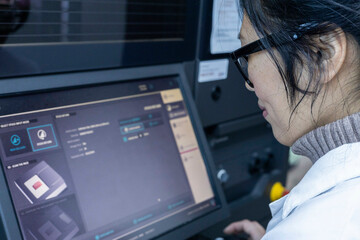 Woman using a touchscreen panel in a medical practice