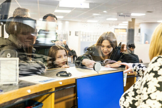 Child and adult at a service counter.