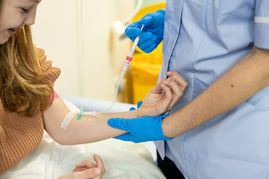 Nurse giving injection to a young patient