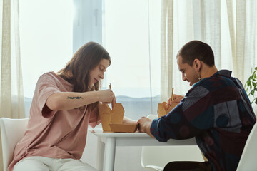 gay couple in casual clothes sit at a table, engrossed in conversation, in a warm and inviting...