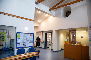 Interior of a brightly lit medical practice with waiting area and reception