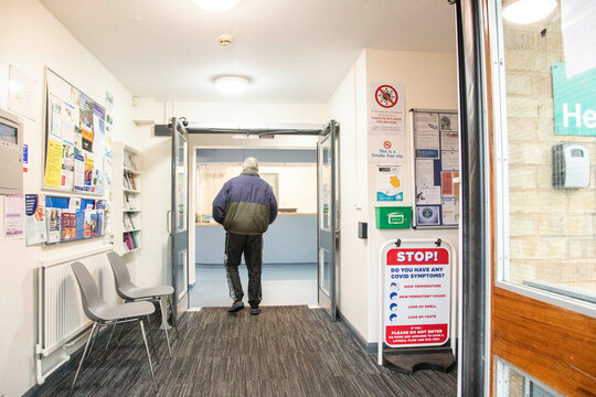 Person exiting through the doorway of a clinic.