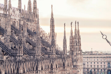 Gothic cathedral spires against a soft sky at dusk.