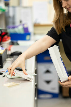 Woman packaging items in an office setting