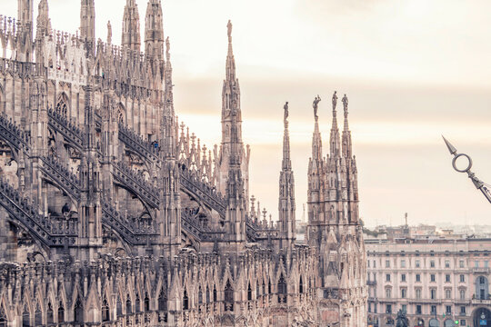 Gothic cathedral spires against a soft sky at dusk.