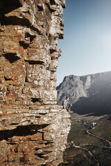 Man, relax and adventure in mountains for trekking, hiking and peace in nature on cliff. Earth, sky and environment in summer for wellness, freedom and journey in countryside for mindfulness or zen