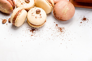 Macaroons with chocolate cream on a light background