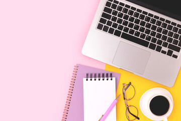 Stationery, laptop, eyeglasses and cup of coffee on a yellow and pink background. Online education...