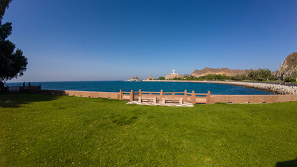 Photography of public park, ocean and mountains in Oman, Muscat during spring day