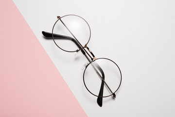 Eyeglasses with round rim for men or women lie diagonally.