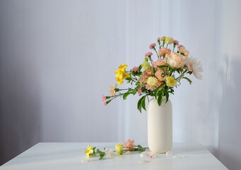 beautiful bouquet in white vase in sunlight
