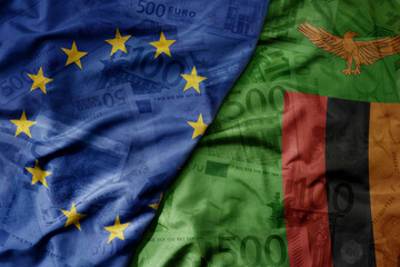 big waving realistic national colorful flag of european union and national flag of zambia on a euro...