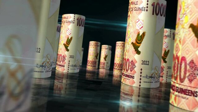Guinea money Guinean francs rolls loop 3d. Money on table. Seamless and loopable abstract concept of economy, finance and business. Camera between GNF 10000 rolled banknotes.