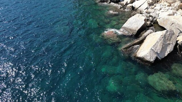 View by drone of the cliffs and shore beneath the monastery in Thassos, Greece, the aegean sea