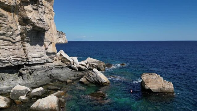 View of the cliffs of Thassos, Greece, the aegean sea clear beneath the rocks