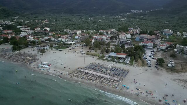 golden beach, thassos, greece from the air by drone showing the town and mountains at sunset