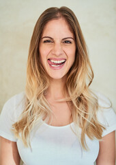 Portrait, funny and woman in studio with tongue out for happy meme, quirky or humor on brown...