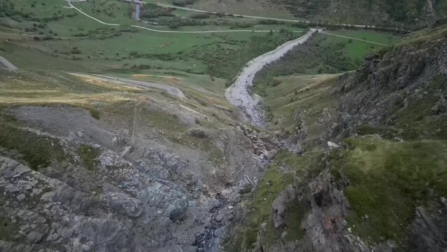 fast flight under bridge along river bed near Val D'isere below the col d'iseran