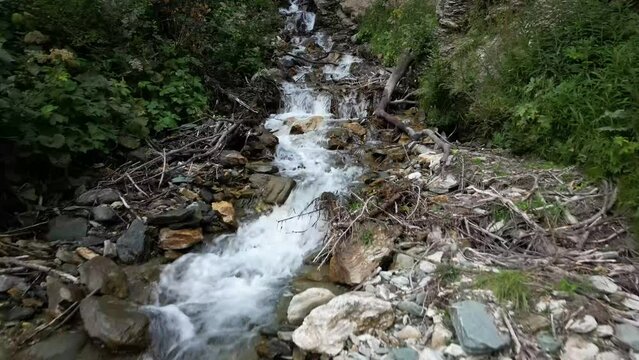 View of river bed and waterfall by drone in tignes french alps