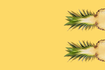 Fresh half sliced pineapple on yellow background. Creative suumer concept.
