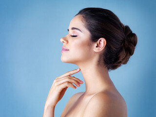 Profile, wellness and woman with beauty, cosmetics and grooming routine on blue studio background....