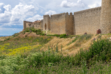 Panoramic view of the medieval walls of the village of book of Uruena with green fields in spring. Village of book.