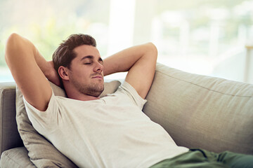 Man, sleeping and sofa in rest for wellness, health and comfort in home with tired or fatigue. Male person, nap and couch for relax, burnout and calm in peaceful, break and eyes closed in living room