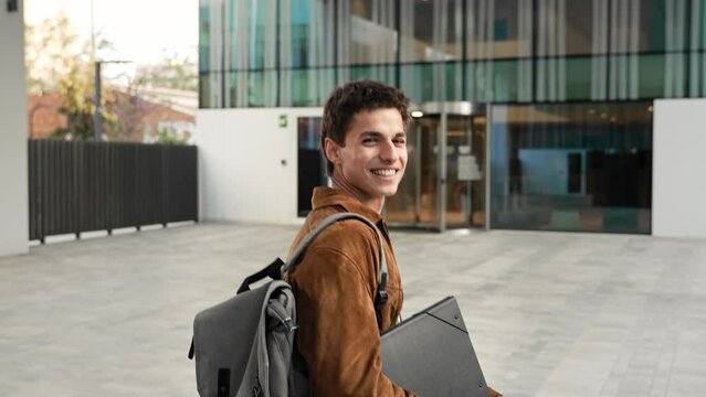 Carefree Young man walking going to the office workplace building