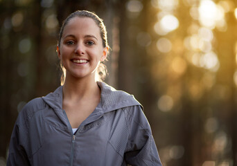 Portrait, smile and woman in forest, fitness and sunshine with happiness, exercise and challenge....