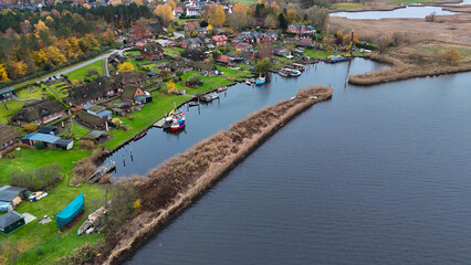 Aerial drone view of houses with thatched roofs of medieval fishing village Gothmund, Germany