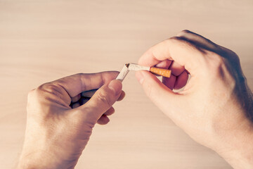 Broken Cigarette in the Hands Closeup