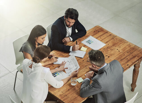 Architect, meeting and business people with blueprint in office for review, discussion or renovation project. Lens flare, architecture firm and employees for conversation, floor plan or teamwork