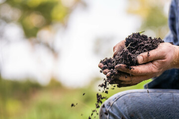farmer holding soil looking at soil carbon in the america