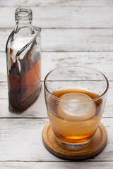 丸い氷のオンザロックとウィスキーのボトル