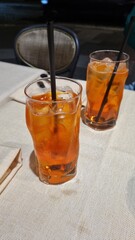 Glasses of iced tea on a table with chopsticks