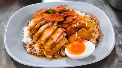 Crispy pork rice on a blue plate on the dining table
